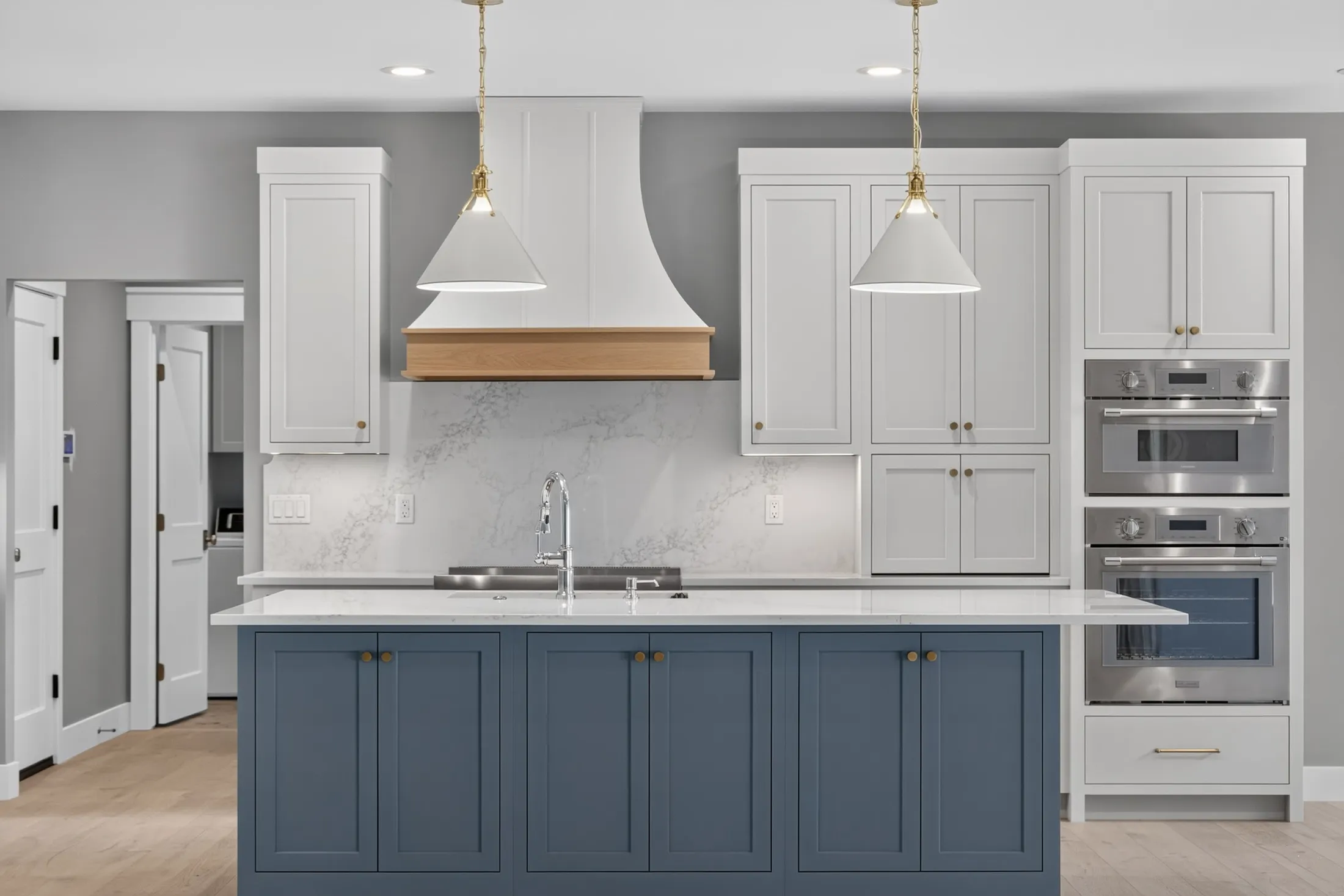 Blue island, white hood with oak band, wall ovens and white cabinetry